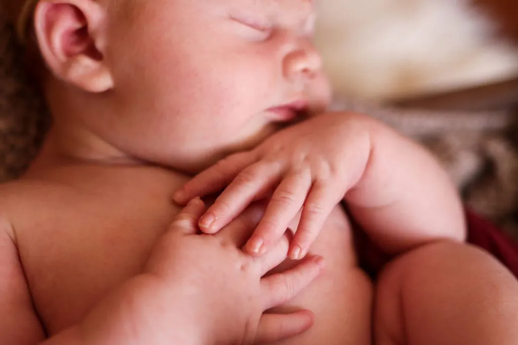 Newborn Baby holding hands