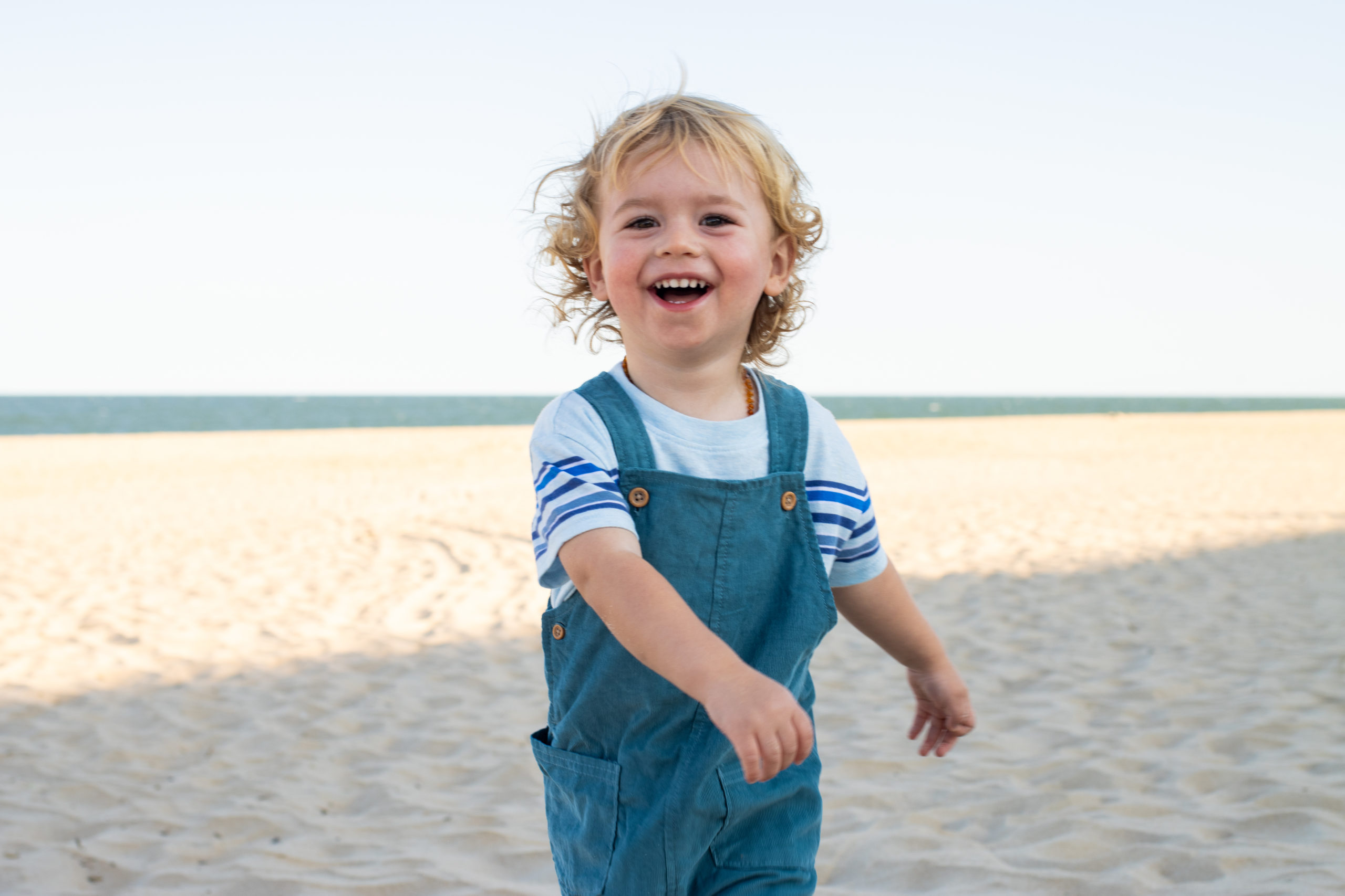 Toddler Walking Happily in Beach
