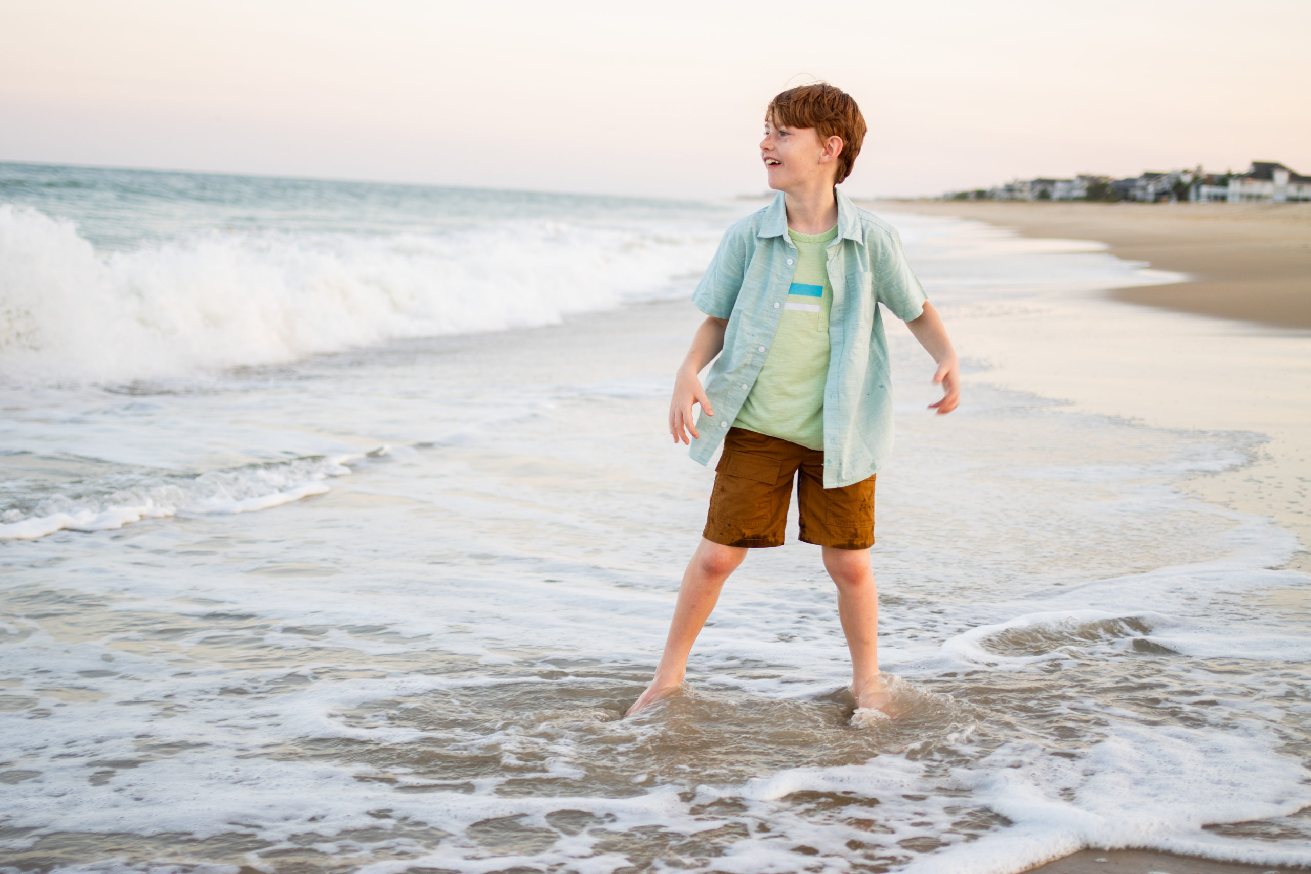 A Boy Standing in Shore of Beach