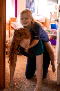 A Child Riding Her Mom's Back