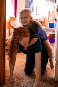 A Child Riding Her Mom's Back