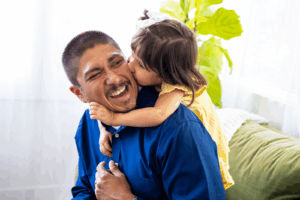 Daughter Hugging and kissing Her Father