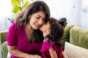 Daughter Kissing Her Mother in Family Photo