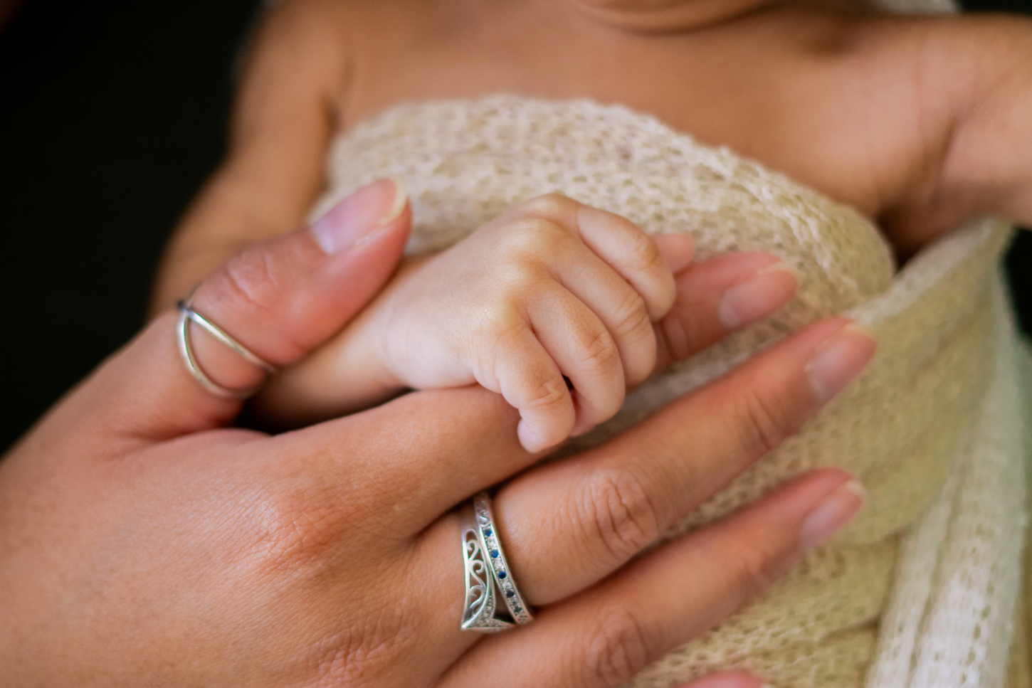 Newborn Hand Grasping Mother’s Finger
