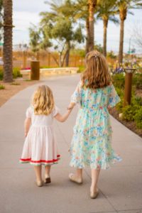 Two children holding hands during a family photo session