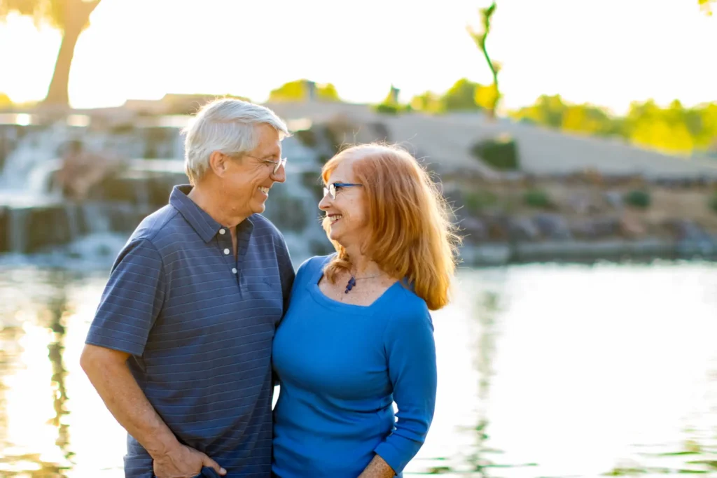 Couples Mini Session with an older couple near a lake during golden hour, sharing a quiet, connected moment
