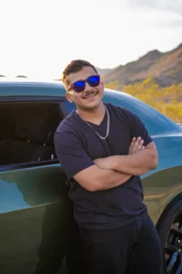 Senior guy leaning on his car during a spring desert photo session in Phoenix