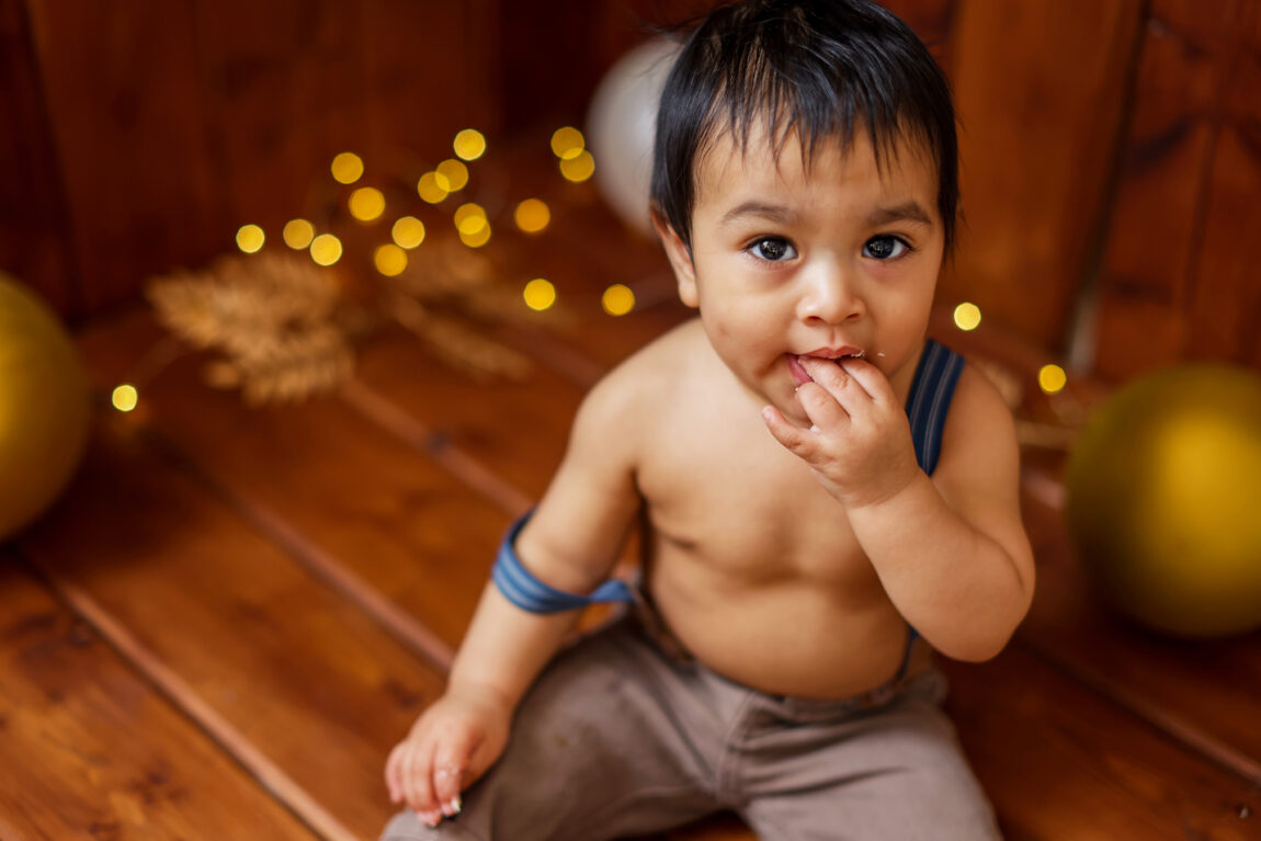First Year Newborn Experience. Baby boy in blue suspenders West Valley Phoenix
