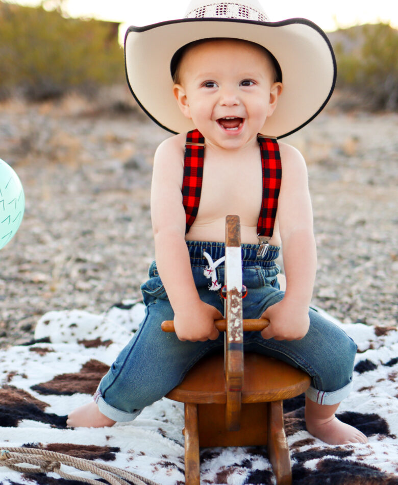 Baby in cowboy hat before cake smash session in the Arizona desert