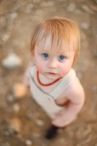 Toddler with blue eyes looking up during holiday card photos in Phoenix