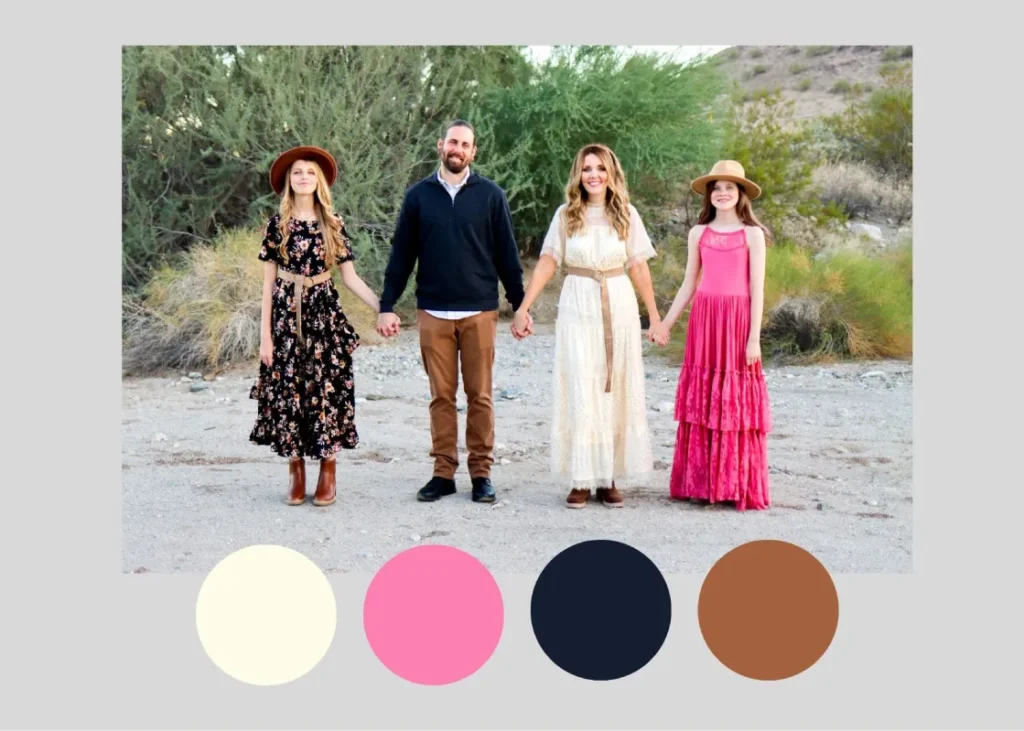 Family holding hands in boho desert outfits with floral, cream, pink and navy tones, an example of what to wear for family photos