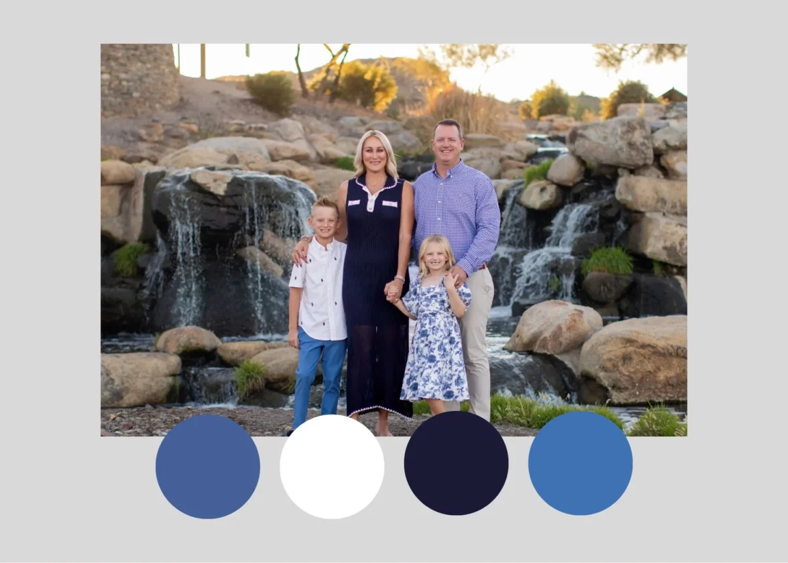 Family of four in coordinated navy and blue outfits by a desert waterfall, an example of what to wear for family photos